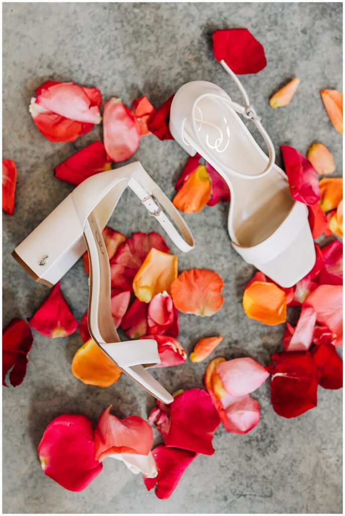 bride's shoes with florals on floor at Pike Lake Beach & Golf Club