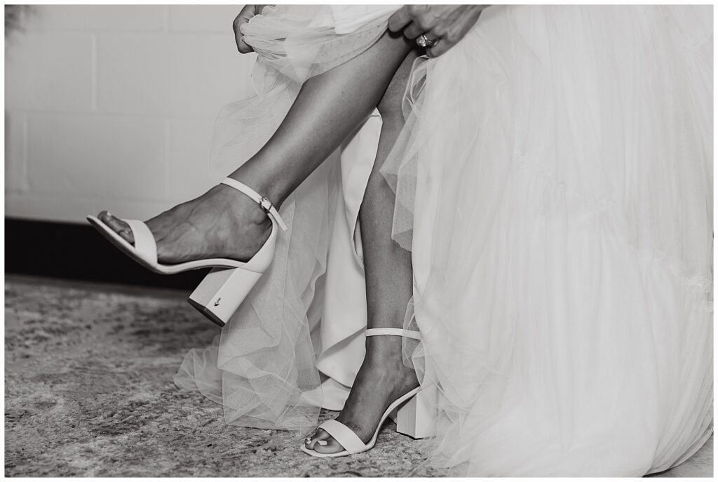 bride putting on shoes at Pike Lake Beach & Golf Club