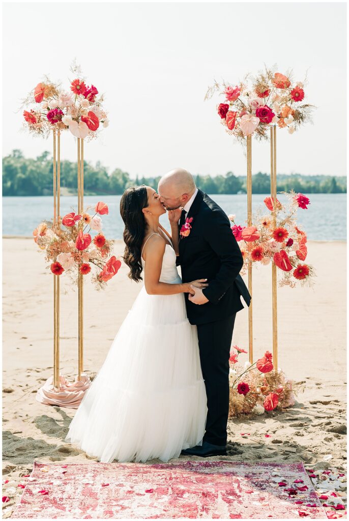 bride and groom's first kiss at pike lake golf and beach club in Duluth, mn