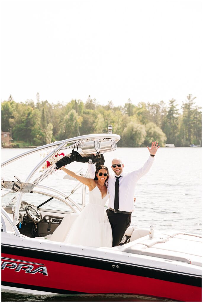 bride and groom celebrating on boat at Pike Lake wedding