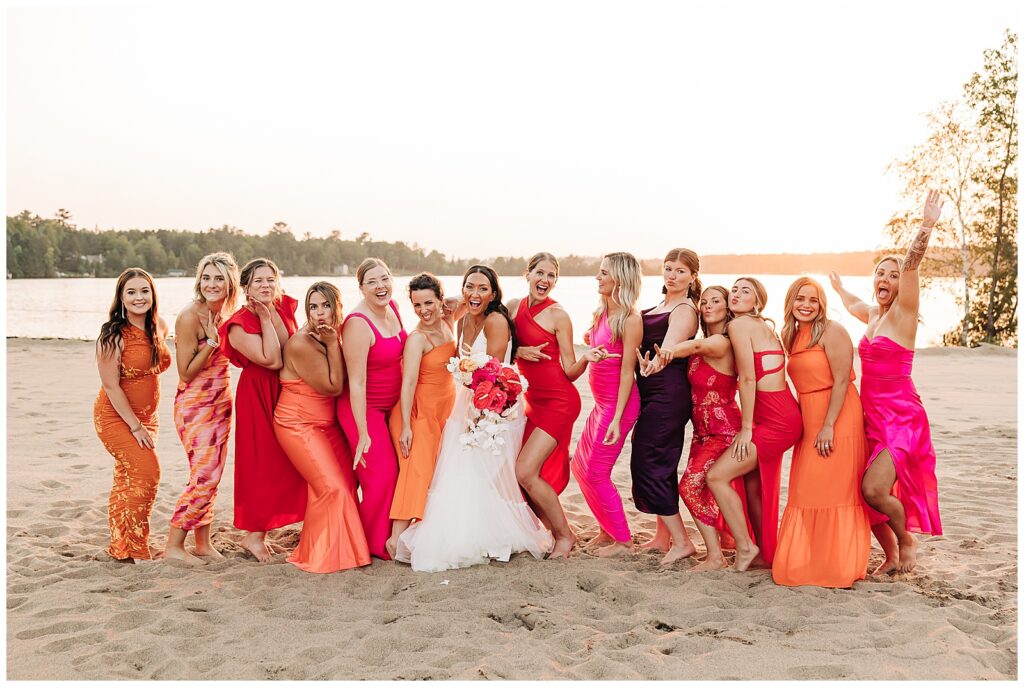 Bride and her girlfriends in bright colored dresses at sunset