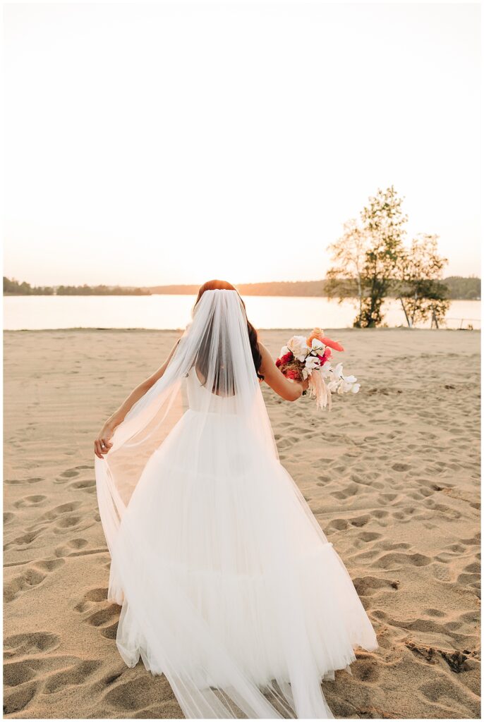 bride walking away into sunset in Duluth, mn at Pike Lake wedding