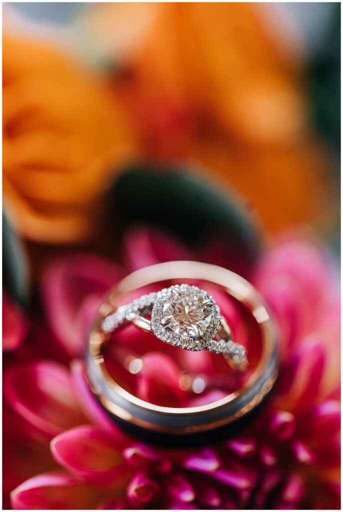 bride and groom's wedding rings on flowers