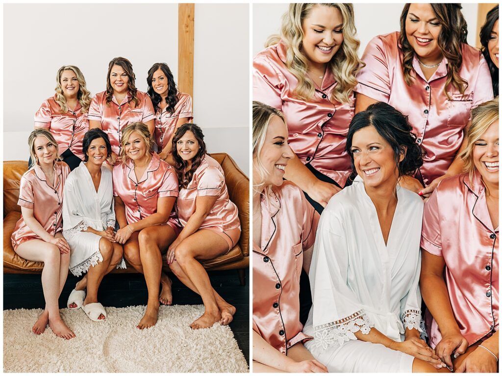 bride and bridesmaids looking and laughing at each other in robes on morning of wedding in bridal suite