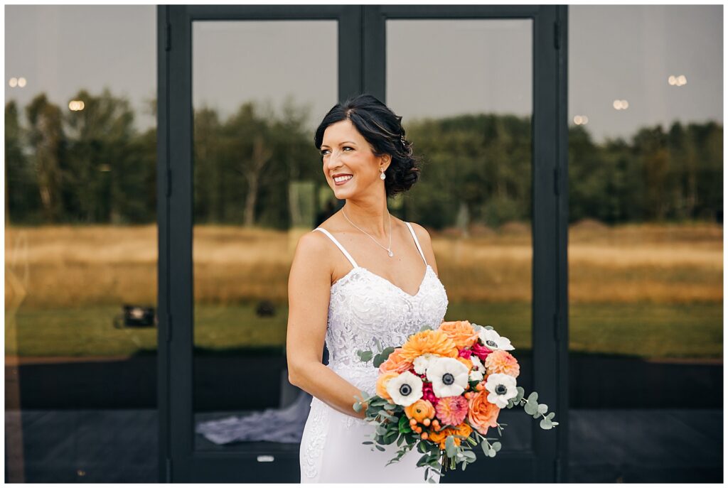 bride holding flowers looking off to the side