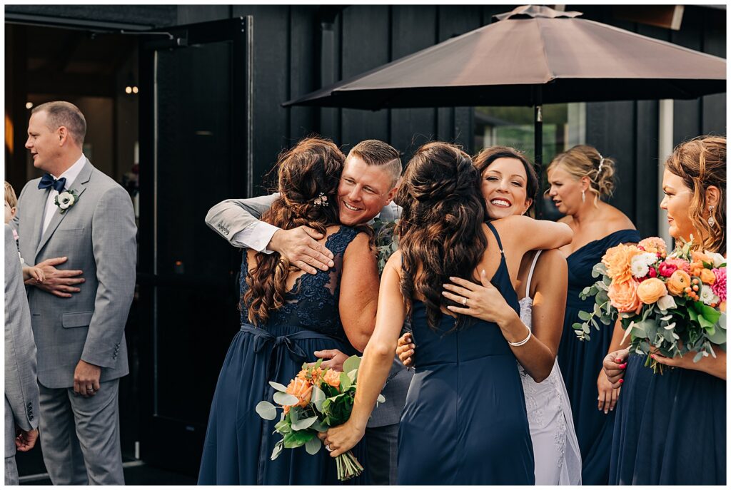 Bride and Groom greeting and hugging bridesmaids after ceremony