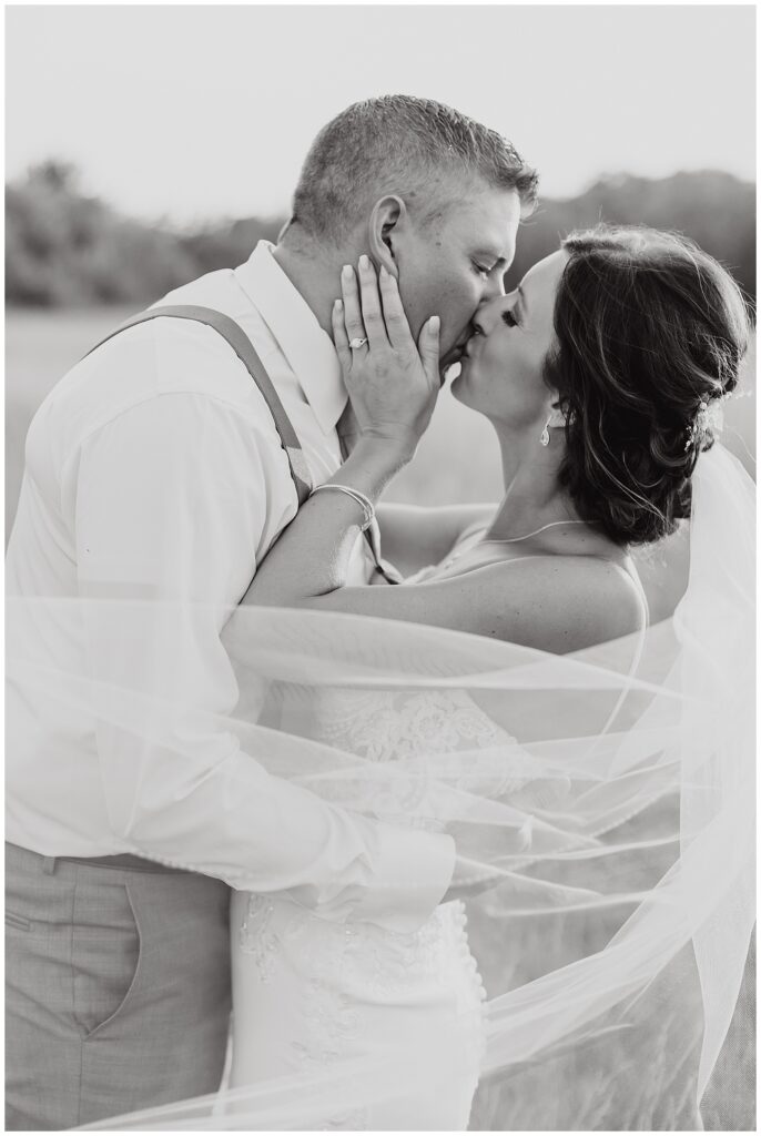 Black and White photo of bride and groom kissing at Ivy Black Weddings & Events